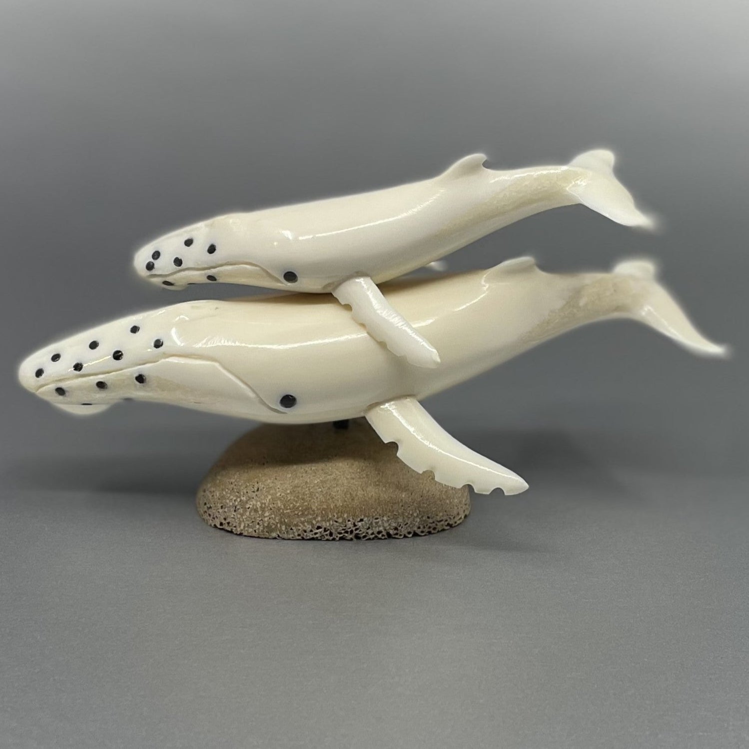 Ivory whale and baby whale figurine